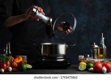 Chef Preparing Dishes, Salt Water, Freezing In Motion On A Dark Blue Background, Fresh Vegetables And Ingredients, Recipe Book