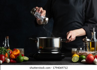 Chef Preparing Dishes, Salt Water, Freezing In Motion On A Dark Blue Background, Fresh Vegetables And Ingredients, Recipe Book