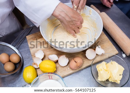 Chef preparing dough at counter in a commercial kitchen