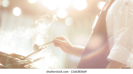 Chef preparing food, frying in wok pan, Close up, Chef cooking in kitchen - Shutterstock ID 1166383669