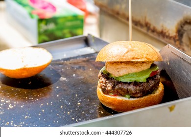 chef preparing a gourmet burger - Powered by Shutterstock