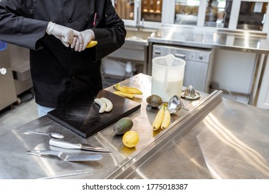 Chef preparing ingredients for making ice cream or yogurt on the kitchen of a small manufacturing. The process of an exotic ice cream preparing