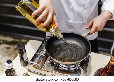 Chef Preparing Olive Oil in a Pan for Making Rosemary Oil. - Shutterstock ID 589858880