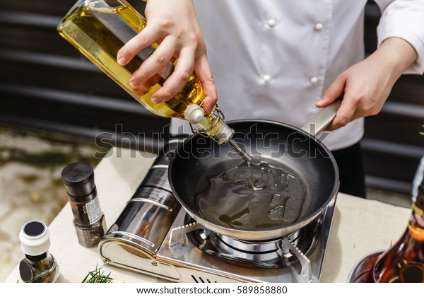 Chef Preparing Olive Oil in a Pan for Making
Rosemary Oil.