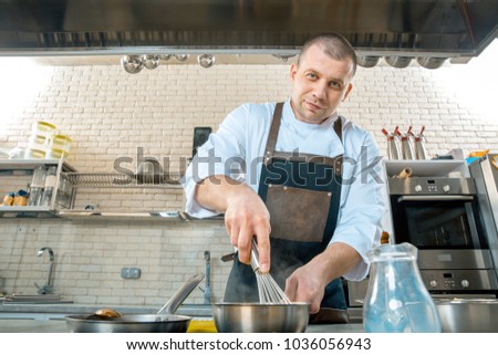 chef preparing a polenta in the restaurant kitchen. cooking process