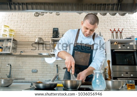 chef preparing a polenta in the restaurant kitchen. cooking process