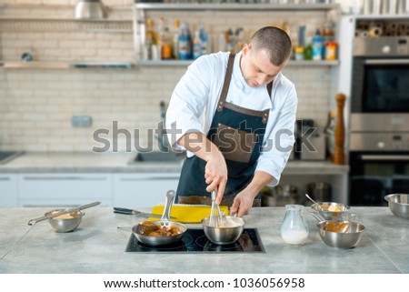 chef preparing a polenta in the restaurant kitchen. cooking process
