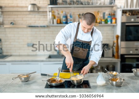 chef preparing a polenta in the restaurant kitchen. cooking process