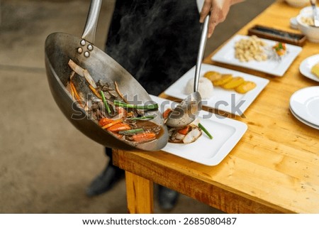 Chef preparing and serving delicious lomo saltado, a traditional peruvian stir fry, onto a plate in a country restaurant