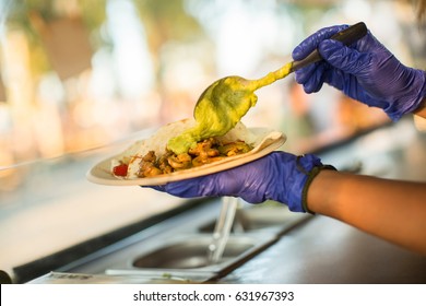 Chef Preparing Tacos With Guacamole In A Food Truck.