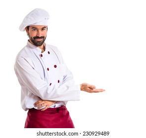 Chef presenting something over white background