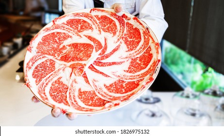 The Chef Presents Premium Rare Slices Kagoshima Wagyu A5 Beef With A High-marbled Texture On A Circle Plate Served For Omakase Meal. Premium Ingredient.