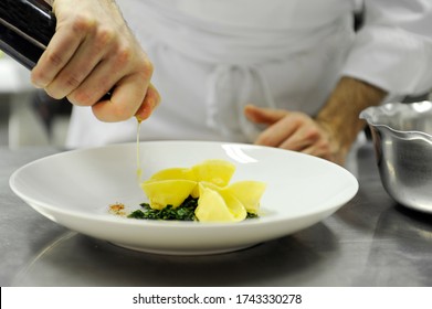 A Chef Puts A Drizzle Of Oil On A Plate Of Tortelli