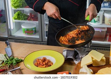 The chef puts pasta from the pan and do the plating. - Powered by Shutterstock