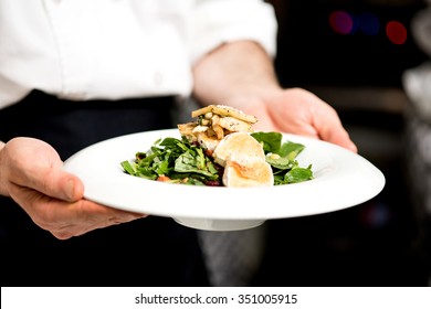 Chef is ready to serve roast goat cheese - Shutterstock ID 351005915