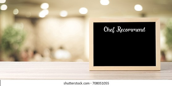 Chef Recommend On Blank Blackboard Standing Over Blur Restaurant Background, Copy Space For Text, Food And Drinks Background, Banner