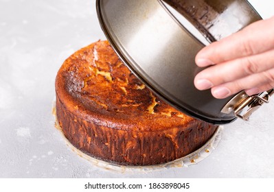 The chef removes the baking ring from basque burnt cheesecake. Spanish dessert