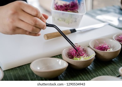 The chef in the restaurant or hotel kitchen cooking just one hand. Cooked with vegetables - Shutterstock ID 1290534943