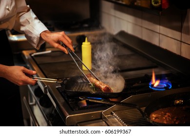 Chef In Restaurant Kitchen Flambeing - Shutterstock ID 606199367