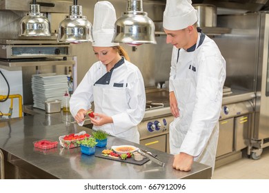 chef in restaurant using torch to burn sugar