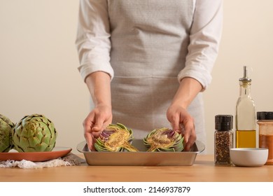 Chef Rubs Preparing To Bake The Artichoke On A Light Background, The Concept Of Cooking Tasty And Healthy Food, Menu, Recipe Book, Detox, Organic Produce Or Local Market Concept