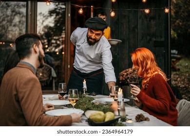 The chef serves food and curates an unforgettable culinary experience for the people.	 - Powered by Shutterstock