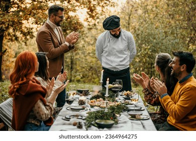 The chef serves food and curates an unforgettable culinary experience for the people.	 - Powered by Shutterstock