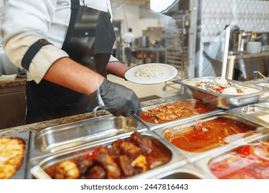 Chef Serving Freshly Cooked Dishes at a Restaurant Buffet During Lunchtime - Powered by Shutterstock