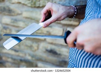 A Chef Sharpening His Knife