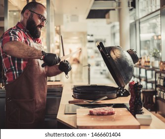 Chef sharping knive for a steak in a restaurant
