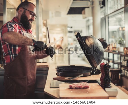 Chef sharping knive for a steak in a restaurant
