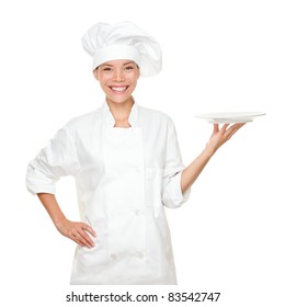Chef Showing Empty Plate. Happy Smiling Portrait Of Female In Chef Uniform And Chef Hat Isolated On White Background. Asian Caucasian Woman Model.