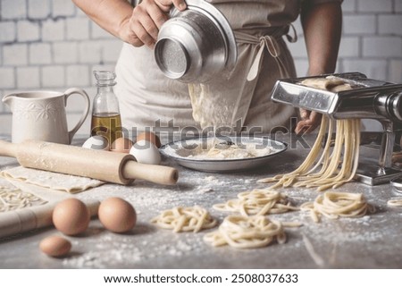 Chef skillfully preparing fresh pasta with eggs and flour, showcasing traditional Italian cooking techniques. Perfect for food photography, culinary arts, and homemade pasta.