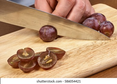 Chef sliced grapes on a cutting board Chef's hands Close-up