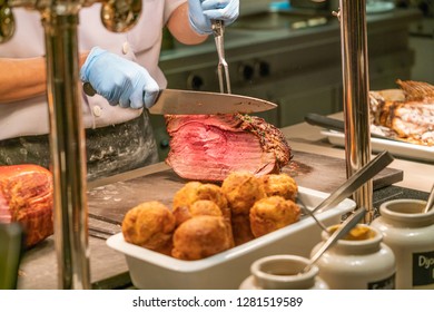 Chef Slicing And Cutting Prime Rib In The Buffet Restaurant