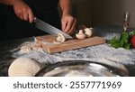 A chef slicing fresh mushrooms on a wooden board, preparing ingredients for a meal.