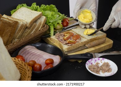 Chef Spreading Mayonnaise On Bread To Make Sandwiches.