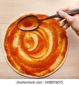 Chef Spreading Sauce On Italian Pizza Base, Top View, Crop