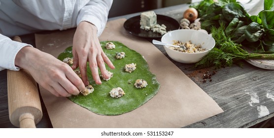 chef step by step, preparing a green ravioli with the addition of spinach dough, stuffed with ricotta and porcini mushrooms. - Powered by Shutterstock