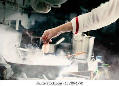 Chef Stir Fry In Wok. Dramatic Cooking 