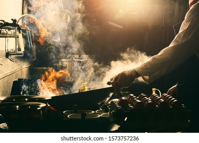 Chef Stir Fry In Wok. Dramatic Cooking With Fire Hard