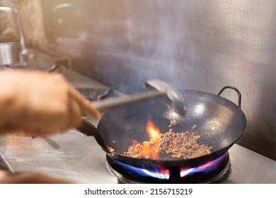 Chef Stir Fry In Wok. Dramatic Cooking With Fire Hard