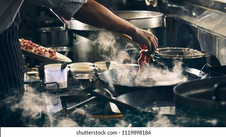 Chef Is Stirring Beef In Wok