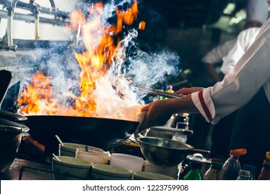 Chef Stirring Cooking With Wok