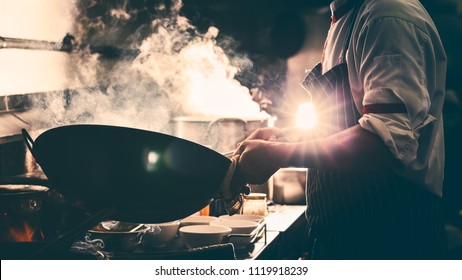 Chef Is Stirring Vegetable In Wok