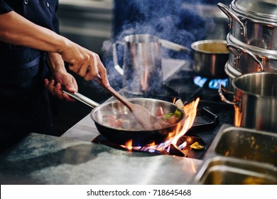 Chef Stirring Vegetables In Frying Pan