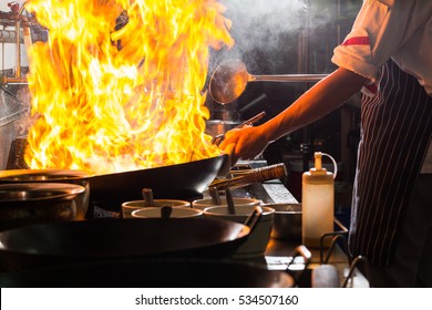 Chef Is Stirring Vegetables  In Wok