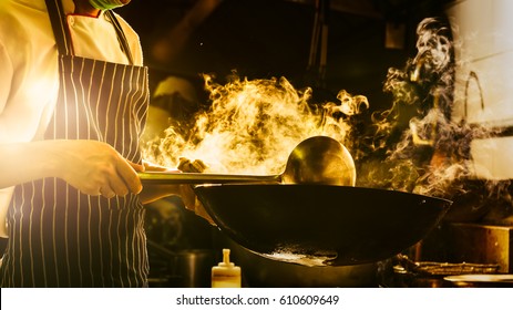 Chef Is Stirring Vegetables In Wok