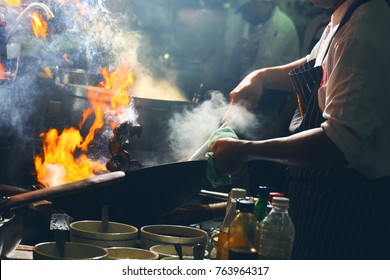 Chef Is Stirring Vegetables  In Wok