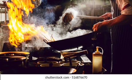 Chef is stirring vegetables  in wok on street food concept - Powered by Shutterstock